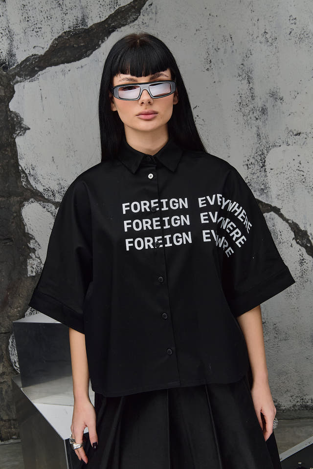 Wicked33 Foreign oversized shirt in deep black, large white “FOREIGN EVERYWHERE” text print on chest and sleeve