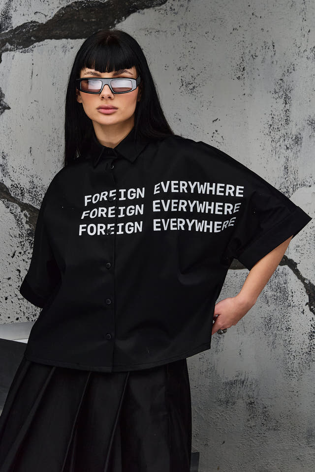 Wicked33 Foreign oversized shirt in deep black, large white “FOREIGN EVERYWHERE” text print on chest and sleeve