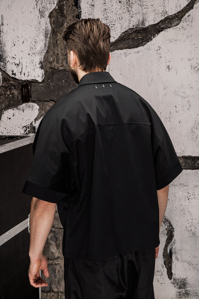 Wicked33 Foreign oversized shirt in deep black, large white “FOREIGN EVERYWHERE” text print on chest and sleeve