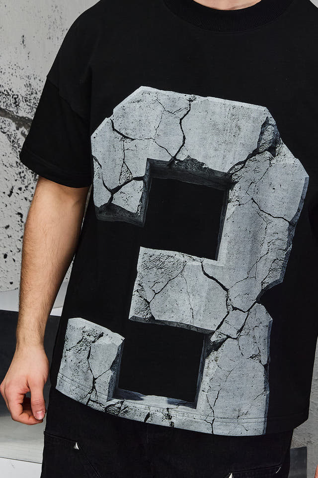 Wicked33 33:FRACTURE oversized t-shirt in black, large cracked stone graphic print with number “3”