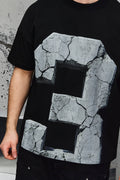 Wicked33 33:FRACTURE oversized t-shirt in black, large cracked stone graphic print with number “3”