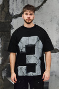 Wicked33 33:FRACTURE oversized t-shirt in black, large cracked stone graphic print with number “3”