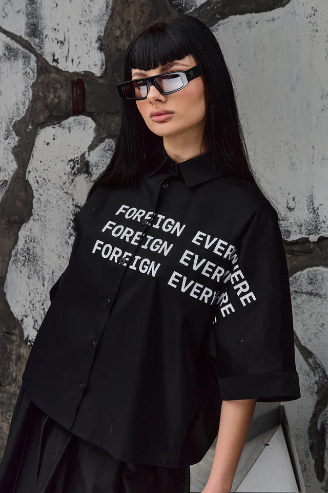 Wicked33 Foreign oversized shirt in deep black, large white “FOREIGN EVERYWHERE” text print on chest and sleeve